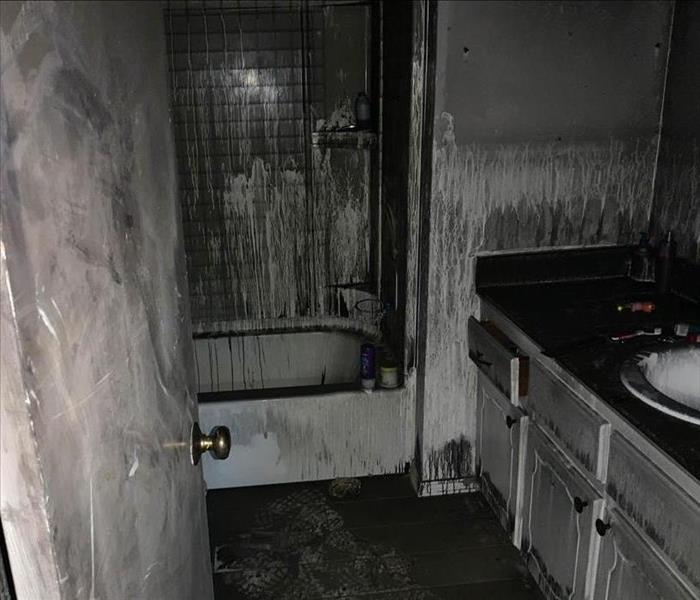Soot covered bathroom after a fire.