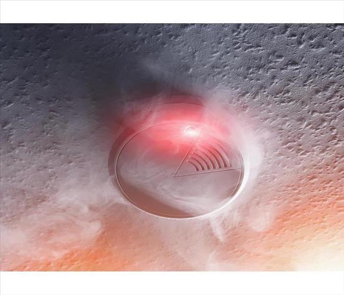 smoke detector with white smoke and red warning light